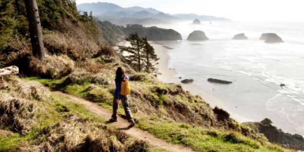 A person standing on a path overlooking a body of water AI-generated content may be incorrect.