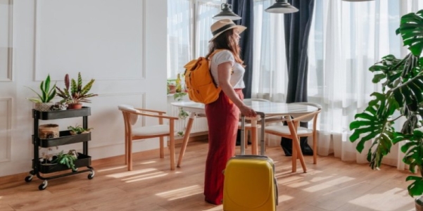 A person with a yellow backpack and a yellow suitcase AI-generated content may be incorrect.