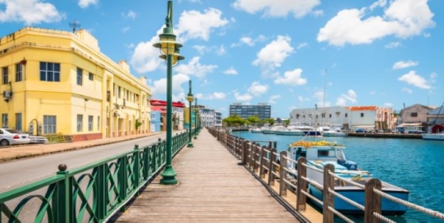A walkway with a body of water and buildings AI-generated content may be incorrect.