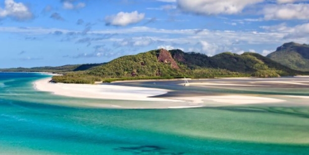 A beach with a white sand and blue water AI-generated content may be incorrect.