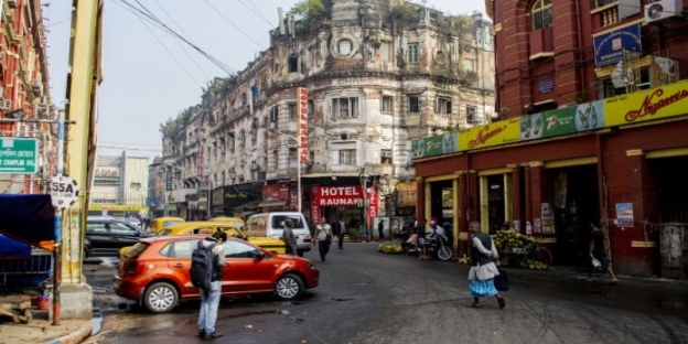 A street with cars and people on it AI-generated content may be incorrect.