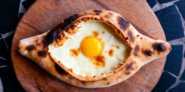 A baked egg with a yolk in the middle of it AI-generated content may be incorrect.